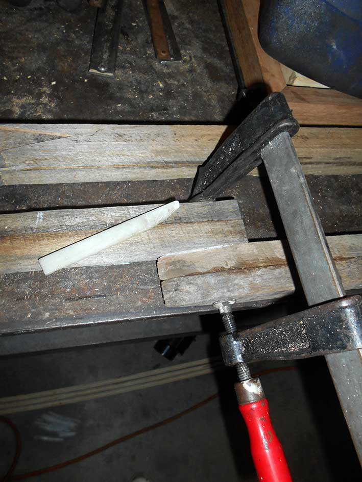 Woodwork using a clamp and chalk to make marks for cutting timber